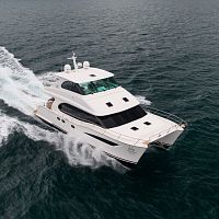 Power catamaran motor yacht PC52cruisingwith enclosed flybridge3-cabin