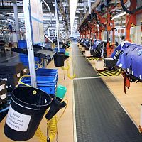 Industrial vehicle conveyor system assembly linefloor-mounted