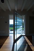 Interior door ONEwoodenpivoting with offset axisglazed