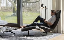 Contemporary fireside chair LE SAC leatherfabricwith footrest